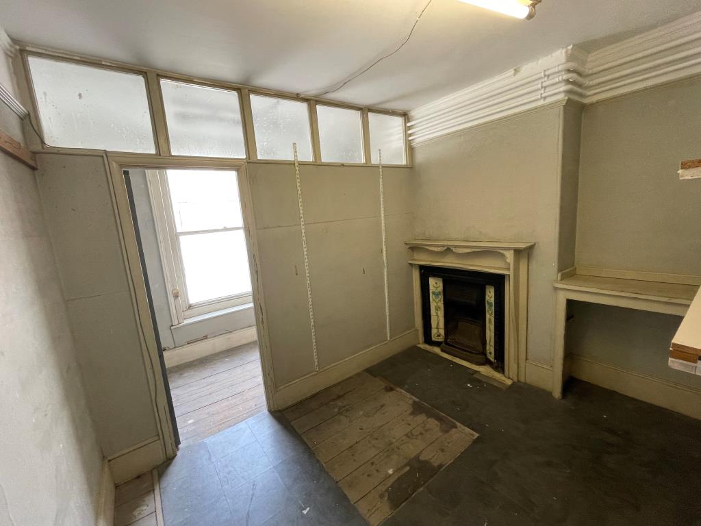Lot: 14 - FREEHOLD VACANT BUILDING WITH RETAIL PREMISES AND POTENTIAL FOR CONVERSION OF UPPER FLOORS - Room with false wall and fire place